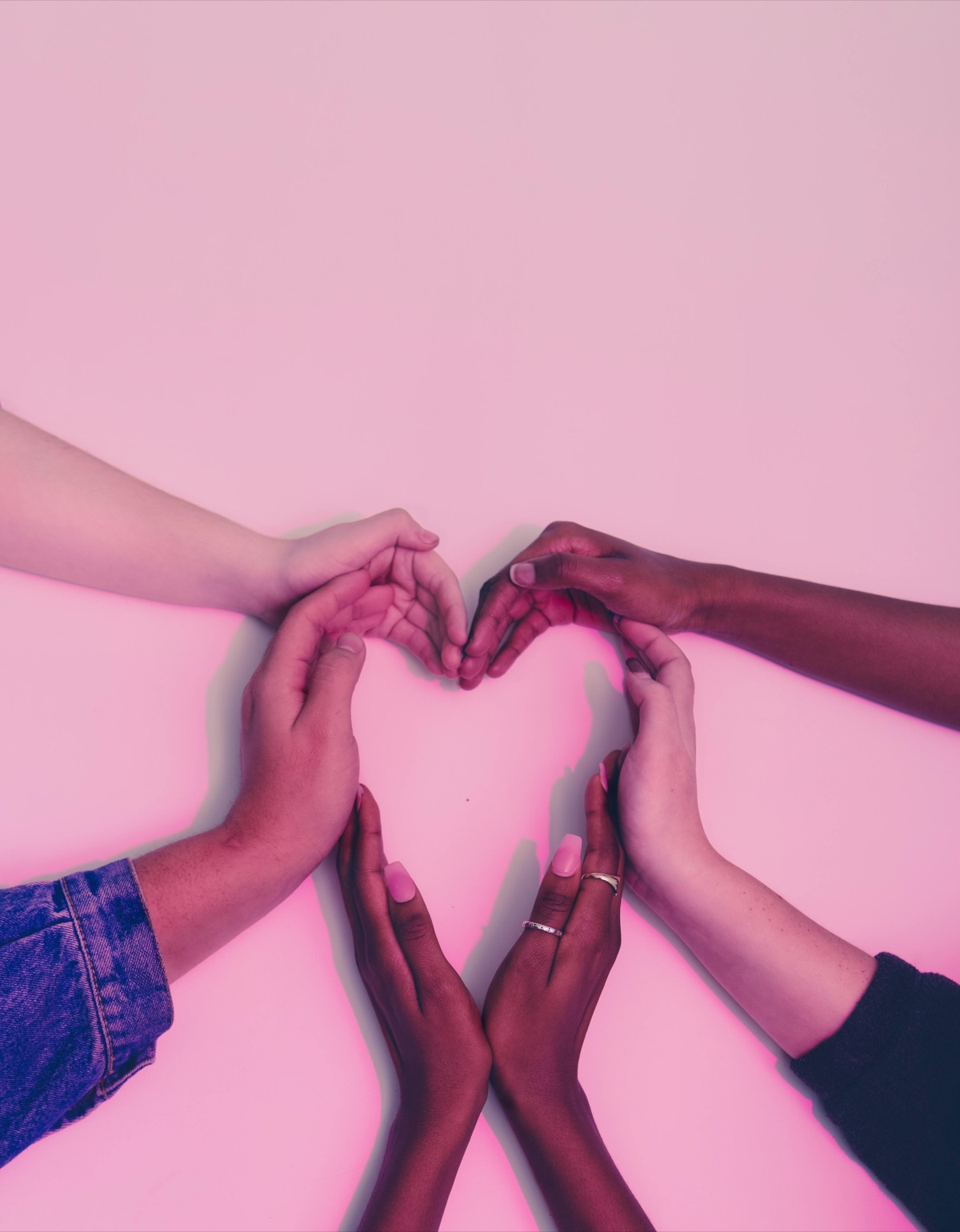 Diverse hands forming a heart shape representing family connection — adoption counseling in Charlotte, NC