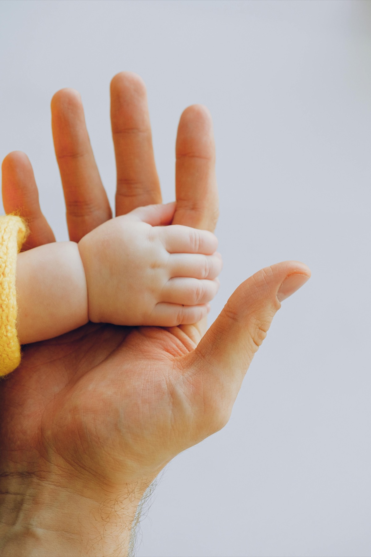 Baby hand grasping parent finger representing healing through connection — trauma therapy in Charlotte, NC